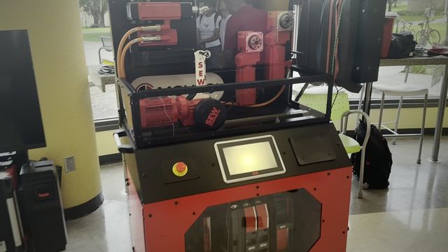 Red SEW-EURODRIVE drive training unit with a control screen.